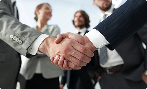 Business professionals shaking hands in a formal setting